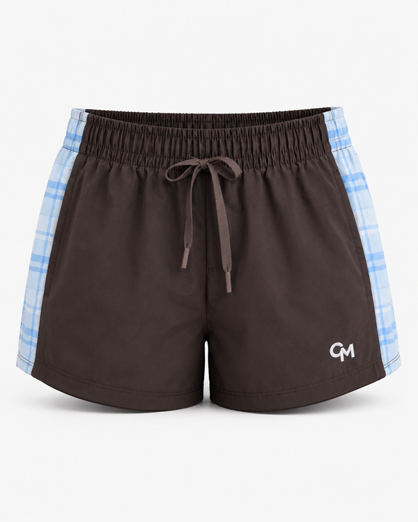 Brown athletic shorts with a white drawstring, blue and white  plaid pattern on the sides, featuring a small white 'CM' logo on the lower left leg.