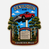 A rectangular embroidered patch with a rounded shield-like border, featuring a red pickup truck jumping over a pole in front of trees and a blue sky. The patch reads “DENILIQUIN -NSW” at the top and “COUNTRY MILE” at the bottom, with a signpost in the center.