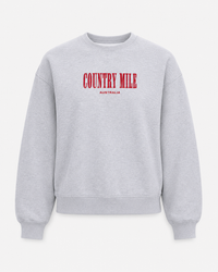 A light gray heather crewneck sweatshirt with 'COUNTRY MILE' printed in red across the chest and 'AUSTRALIA' in smaller red text below, shown against a light gray background.